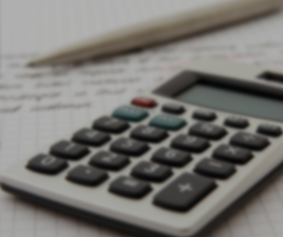 A blurry picture of a calculator and pen.
