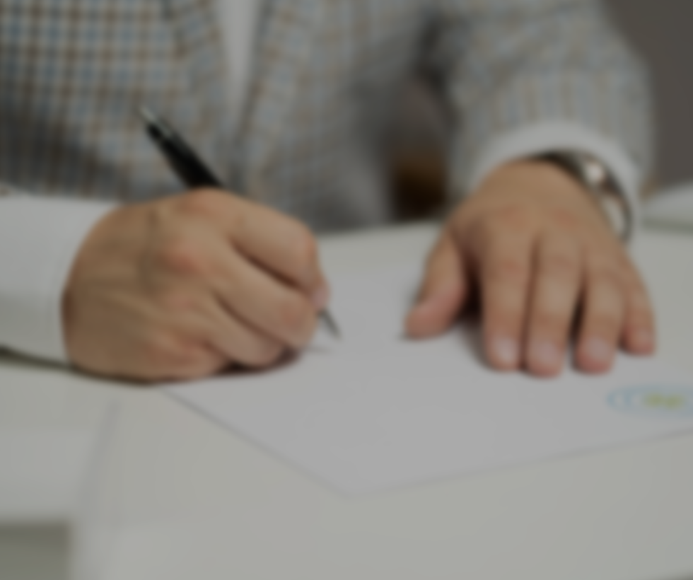A blurry picture of someone signing documents.