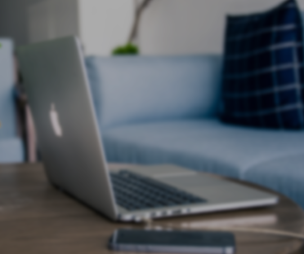 A Blurry picture of a laptop on a coffee table.